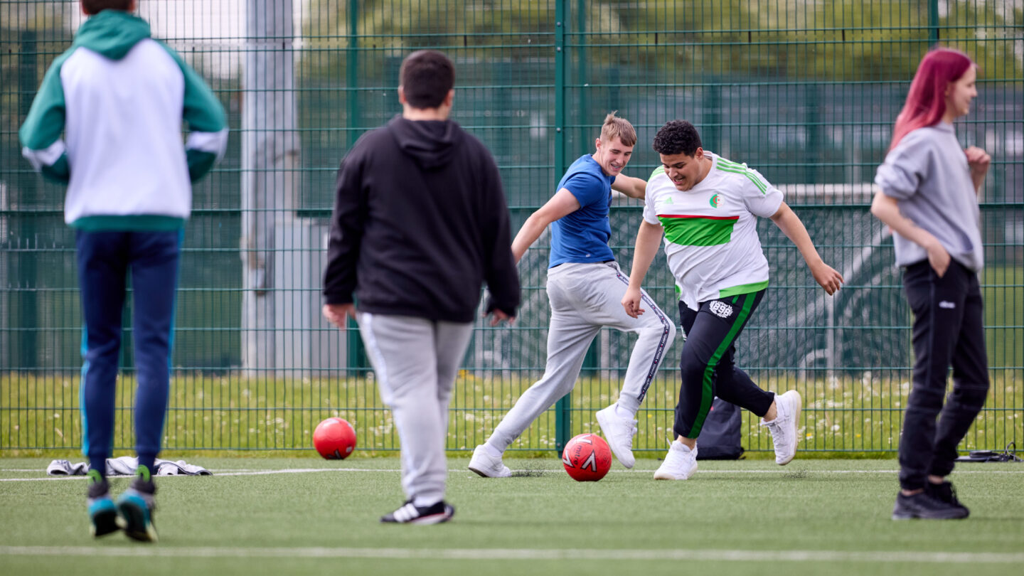 students playing football outdoors