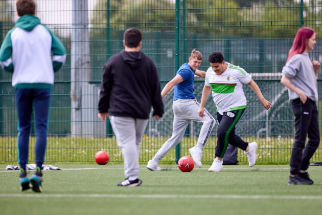 students playing football outdoors