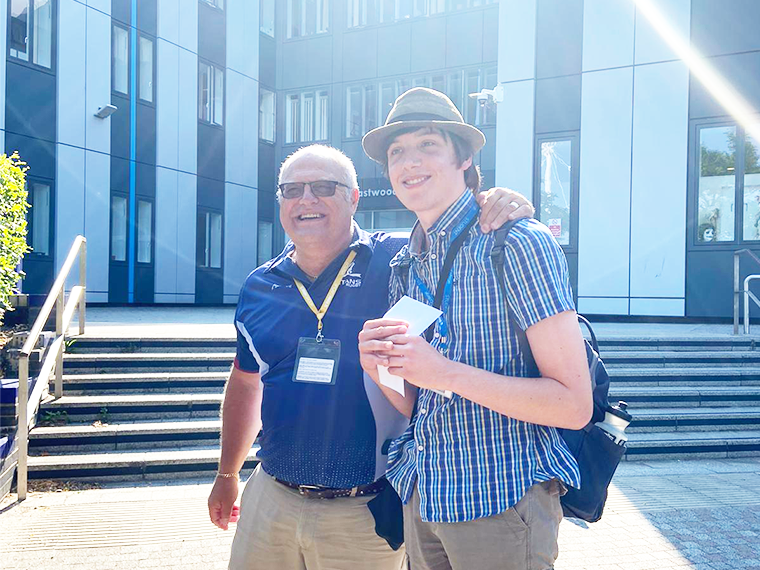 Award winning Creative Media Production student Blake Morley stood with their tutor outside Rotherham College.